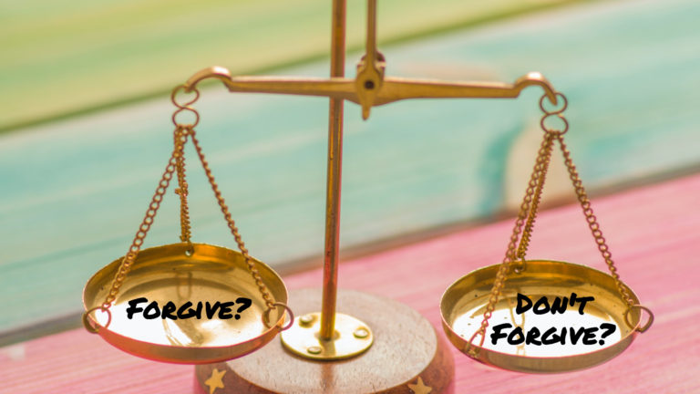 Brass scale with the word "Forgive?" on one side and the phrase, "Don't Forgive" on the other