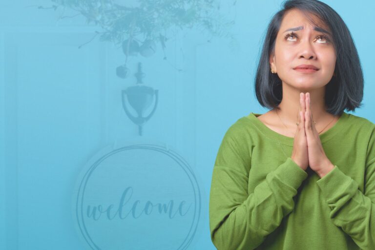 Dark-haired woman, hands folded in prayer, looking upward in exasperation. This image is laid over a screened image of a front door with a wreath with the word "welcome"